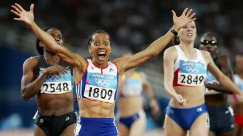 Getty Images Kelly Holmes of Great Britain celebrates after she won gold in the women's 800 metre final on August 23, 2004 during the Athens 2004 Summer Olympic Games at the Olympic Stadium in the Sports Complex in Athens, Greece