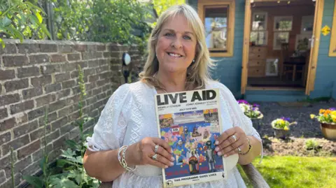 Andrew Marshall/BBC Sue Goddard pictured with the Live Aid programme from the concert on 13th July, 1985.
