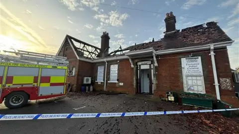 Luke Deal/BBC The roof of a brick building is partially burnt. In places there is just a timber shell remaining, with holes in other parts of the roof.