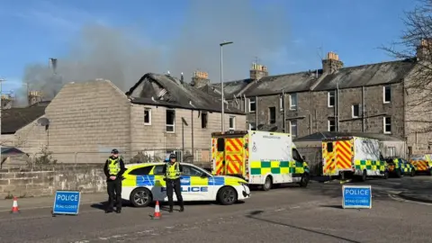 Police and ambulance crews at the scene of fire