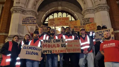 LDRS picture of protesters outside town hall with placards saying "you can't mould us into silence"