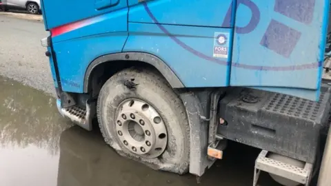 Electricity North West One of the flat tyres on the lorry