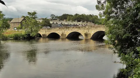 Traffic crossing Otley Bridge over the River Wharfe