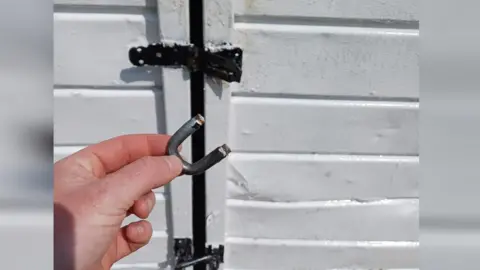 Castor and Ailsworth Cricket Club A damaged door at Castor and Ailsworth Cricket Club