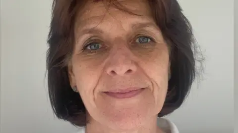 Tina Russell Headshot of Tina Russell who has short brown hair and is wearing a white shirt. 