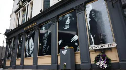 ADAM VAUGHAN/EPA/Shutterstock The Crown pub, where Black Sabbath played their first gig in Birmingham. A picture looking up at the building with a flower tribute outside following Ozzy Osbourne's death.