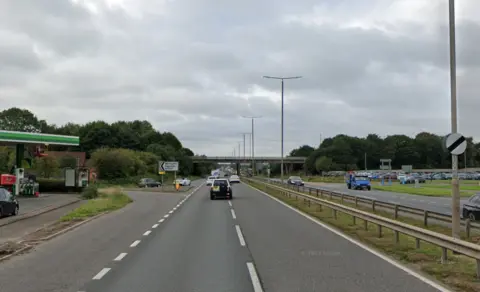 Google Streetview The Eggington junction of the A38 motorway with petrol stations on both sides of the road, close to the bridge exit slip road opposite