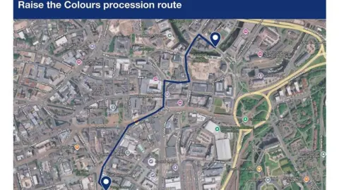 Google/South Yorkshire Police A map with the title “Raise the Colours procession route” displayed in a dark blue banner across the top. The map is an aerial view of a city centre, with roads, buildings, and landmarks clearly labelled.
A blue line is drawn on the map to illustrate the route of the procession. The route begins at a marked location near “Peace Gardens” toward the lower left of the map, then travels through several streets in the city centre. The line passes by notable places such as Sheffield Town Hall, Sheffield Cathedral, and the National Videogame Museum, continuing through areas labelled High Street, Exchange Street, and Castlegate.
Two location markers are visible along the route - one near the starting point at Peace Gardens and another near the end of the route at a site close to “Castlegate Grey to Green Park”.