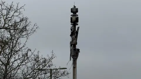 Burnt telephone mast next to the A40.
