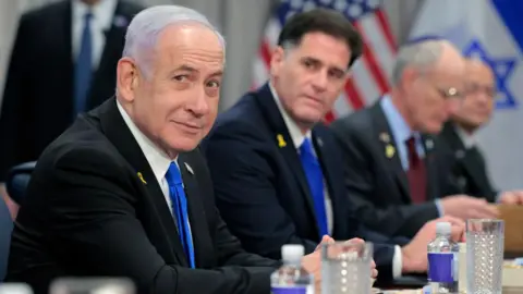 Getty Images Netanyahu looks towards the camera during a meeting