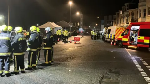 Emergency service crews at a road closure