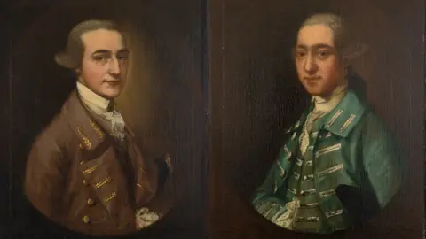 Dan Weill William Tugwell and Thomas Tugwell. William wears a brown regency coat and has a cravat, while Thomas has a green overcoat on. Both have wigs and were painted on a brown background.