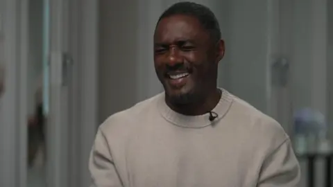 Sir Idris Elba laughing 