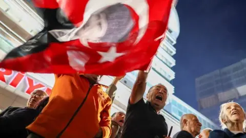 A man waves a Turkish political flag
