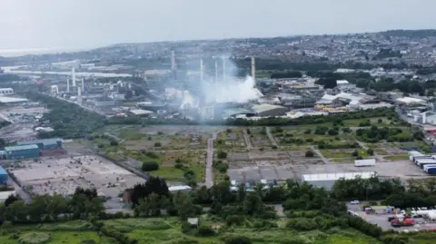 BBC Drone footage showing white mist from a building qhiqhhidrdidrinv