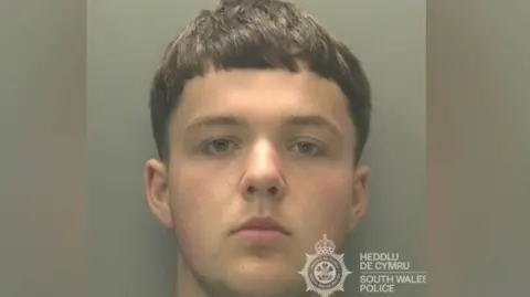 South Wales Police Police mugshot of a man with short brown hair