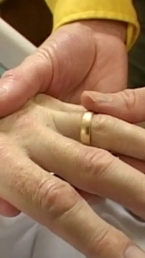 A ring being put on a finger.