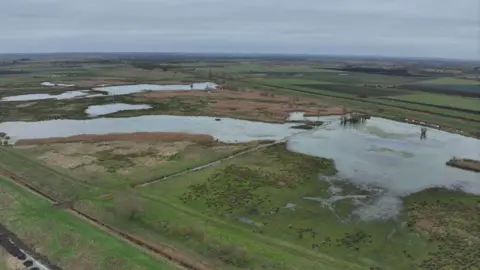 FEPP Burwell Fen after the restoration in December. At least half the site is covered in expanses of water. In the distance is grey sky.