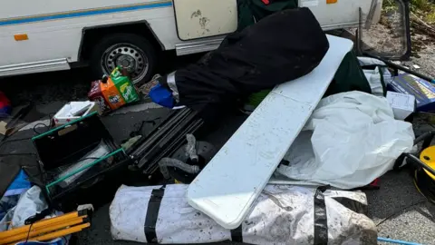 Carl Gratty Items from the caravan emptied outside the caravan