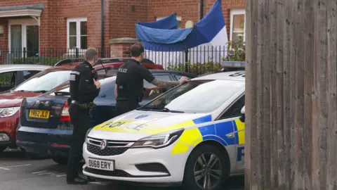 Police officers at the scene in School Lane in Banbury, Oxfordshire after an 88-year-old man died at an assisted living facility.