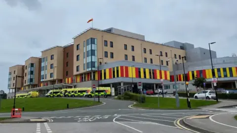 LDRS A large multi-storey building with a number of ambulances parked outside