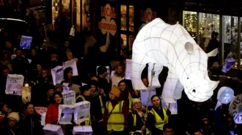 A white rhino lantern being paraded through Bedminster as part of the annual winter lantern parade