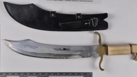 West Yorkshire Police A large hunting-style knife on a table.