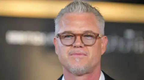 Getty Images Eric Dane wears glasses and looks at the camera 