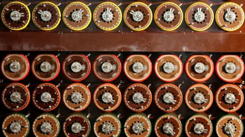 Reuters A British Turing Bombe machine is seen functioning in Bletchley Park Museum in Bletchley, central England, September 6, 2006. The machine consists of a regular grid of exposed wheels or cogs, most with letters around the circumference.