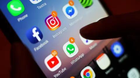 PA Media A close up of a smart phone screen with different apps on it including Instagram, Facebook and WhatsApp.
