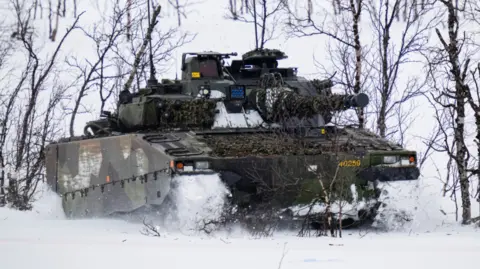 AFP via Gambar Image Swedty Swedish-Swedish-Swedish soldiers riding Combat Vehicle 90 (CV90)