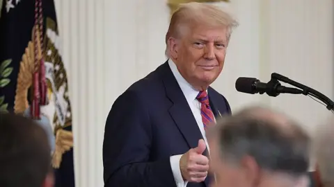 Trump gives a thumbs up at a bill signing ceremony on Friday. 