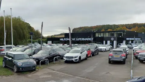 Google Cars outside a showroom that Aldi wants to demolish