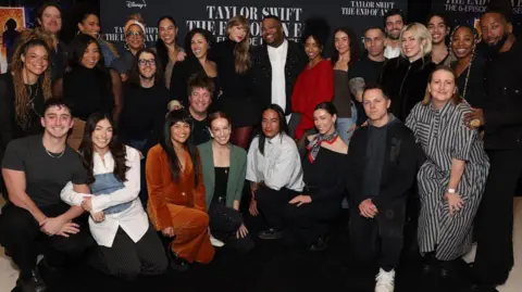 Disney Taylor Swift poses with the crew and dancers from her Eras tour