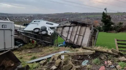 Photograph of tornado damage at Hill Top Farm in Millbrook, showing an overturned horse box