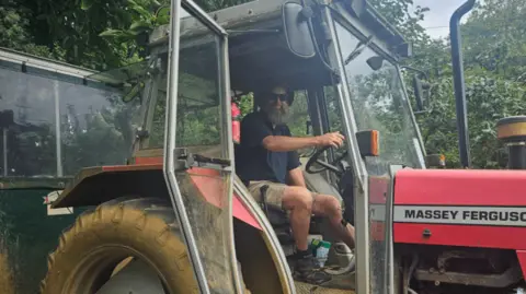 Edward Withers sat in a tractor