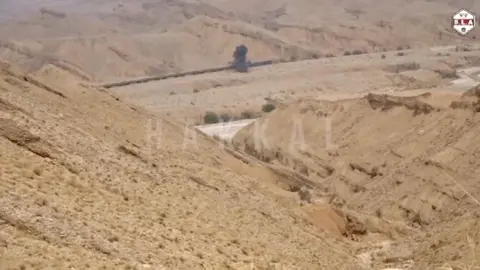 Reuters/Hakkal Media Footage shows a plume of smoke rising from a train in the distance