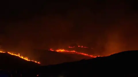 Several wildfires are seen tearing through hillside at night in Turkey