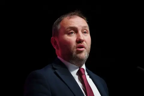 PA Media Scottish Secretary Ian Murray speaks during the Labour Party Conference. The image is cropped to show Mr Murray from the shoulders up and he speaks in front of a dark background.