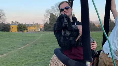 @comeflywithmax Max in a hot air balloon holding a dog