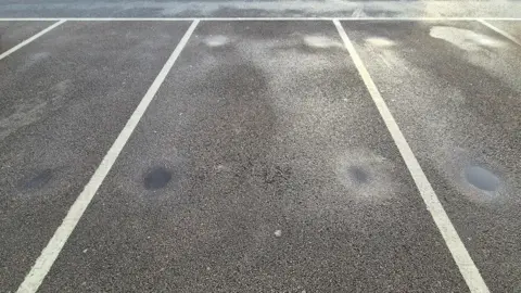 Stuart Woodward/BBC Three empty car parking spaces