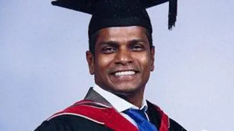 Terry Skitmore Amin Abdullah on his graduation day wearing a cap and gown