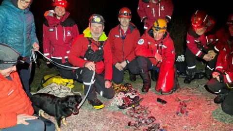 Assynt Mountain Rescue Team Dog with mountain rescuers.