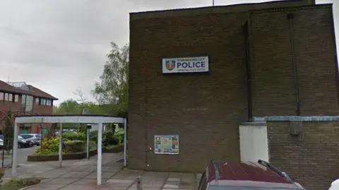 Google A brick building with the logo for Thames Valley Police on the side during a grey day.