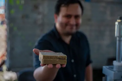 Fritz Pinnow Hugo Daniel Chávez holds a bar of soap produced from used kitchen oil