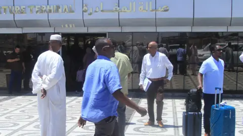 People at an airport terminal in Khartoum