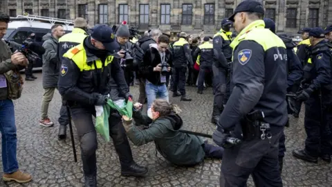 ROBIN VAN LONKHUIJSEN/EPA-EFE Dutch police detain pro-Palestinian protesters on Dam Square in Amsterdam, the Netherlands, 10 November 2024