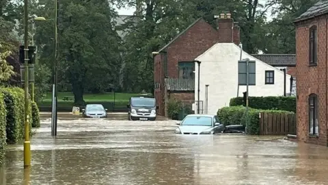 Karl Bird/BBC Street and cars submerged after flooding in Horncastle
