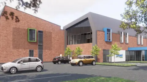 The building is low level and has brown  brick coloured walls, with two wings in the image. There is a car park with cars in the foreground.