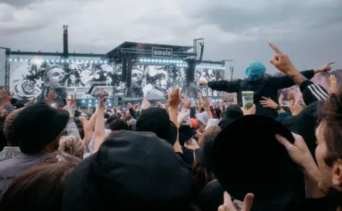 Hans Lucas via AFP Global shot of the crowd attending the last show of the band Oasis in Heaton Park Manchester on Sunday the 20th of July, 2025.
